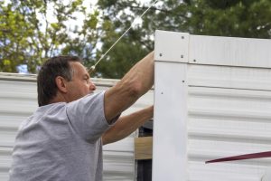 man cleaning an rv