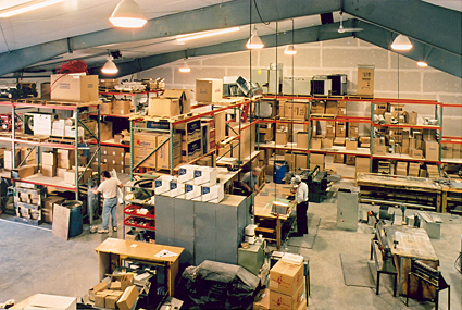 A view of a warehouse with shelving to store parts and equipment.